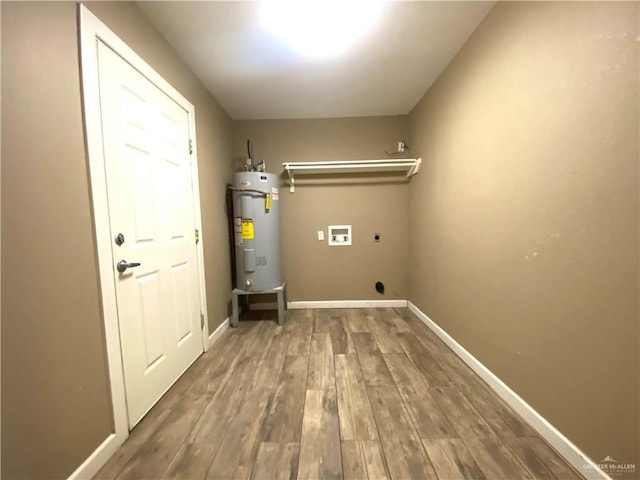 laundry room with water heater, hookup for a washing machine, dark hardwood / wood-style flooring, and hookup for an electric dryer