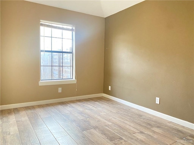 unfurnished room with light wood-type flooring and a healthy amount of sunlight