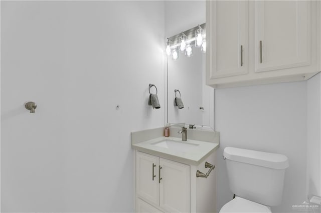 half bathroom featuring toilet and vanity