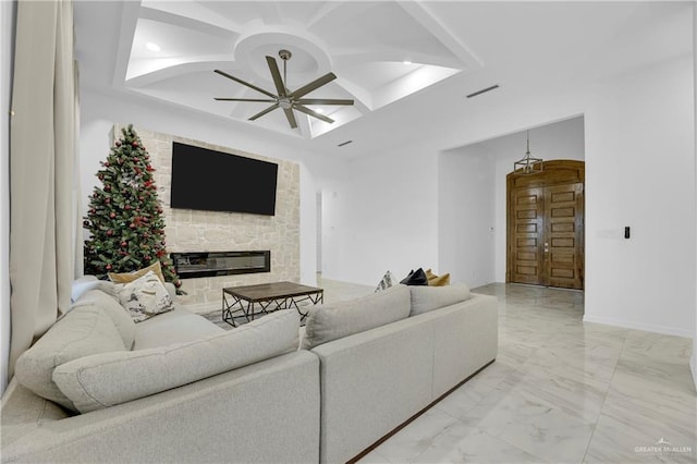 living room with ceiling fan, marble finish floor, a fireplace, coffered ceiling, and visible vents