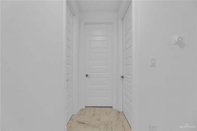 hallway with marble finish floor