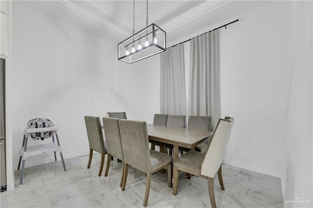 dining area featuring marble finish floor, baseboards, and an inviting chandelier