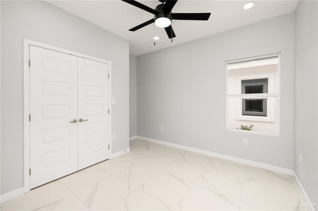 unfurnished bedroom with ceiling fan and a closet