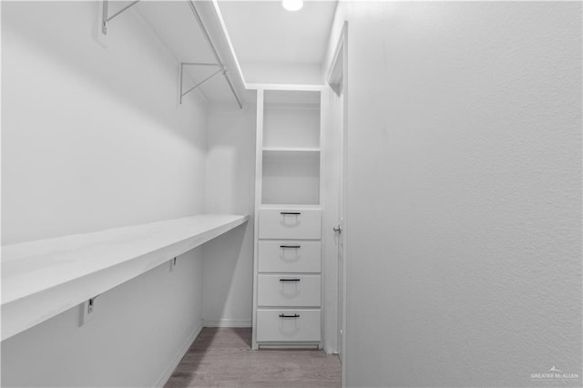 spacious closet with light wood-style floors