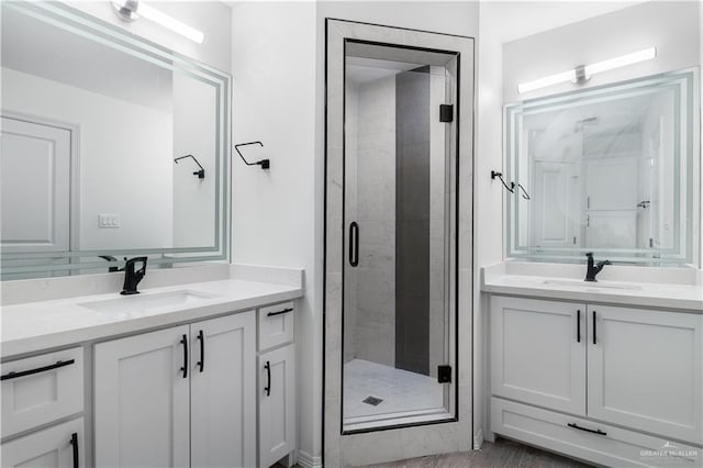 full bathroom featuring a stall shower and vanity