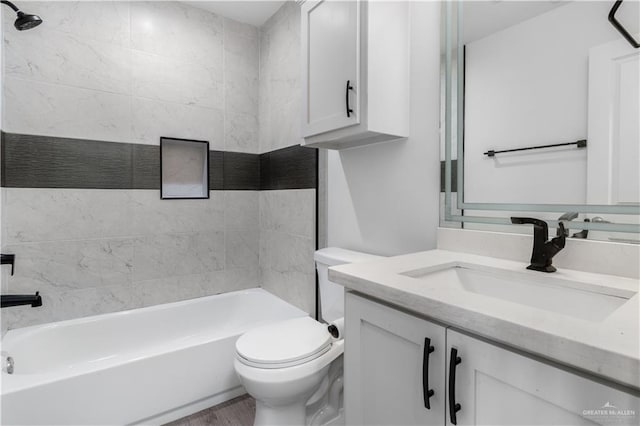 bathroom featuring wood finished floors, vanity, toilet, and shower / bathtub combination