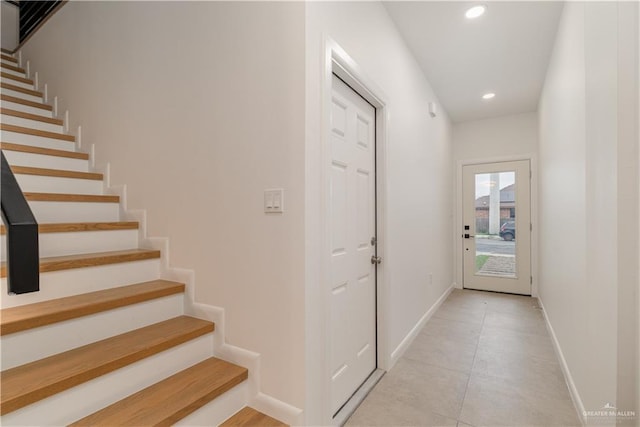 doorway featuring light tile patterned flooring