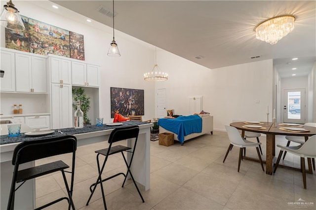 tiled dining area with a notable chandelier