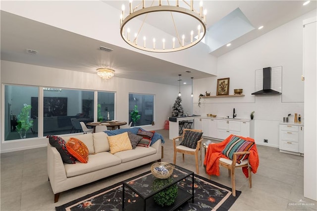 living room with sink, high vaulted ceiling, and a chandelier