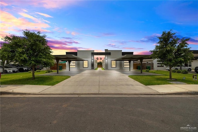 903 W Smith Dr, Pharr, TX 78577 - contemporary home featuring a lawn, stucco siding, and a carport