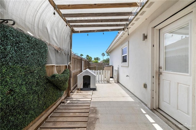 903 W Smith Dr, Pharr, TX 78577 - view of side of home with stucco siding, fence, and a patio area