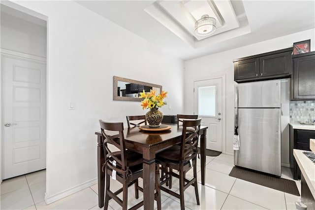 903 W Smith Dr, Pharr, TX 78577 - dining area with a raised ceiling, baseboards, and light tile patterned floors
