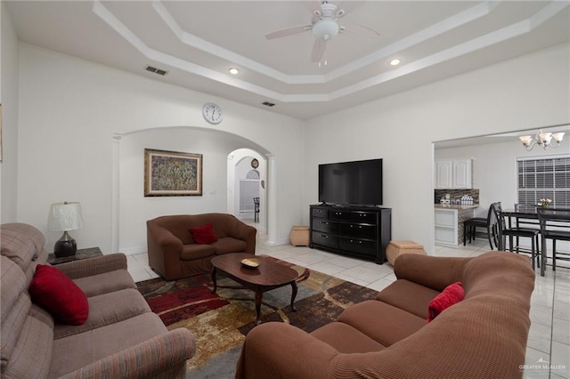 7600 N 23rd Cir, Mcallen, TX 78504 - living area featuring arched walkways, a tray ceiling, recessed lighting, ceiling fan, and a chandelier