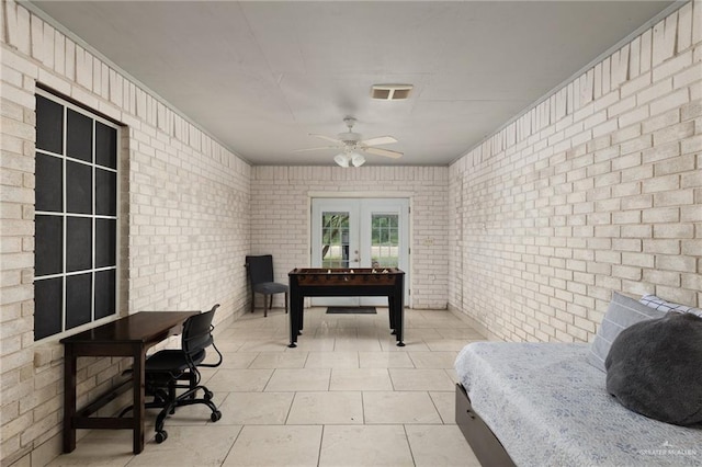 7600 N 23rd Cir, Mcallen, TX 78504 - bedroom with brick wall, french doors, and light tile patterned floors