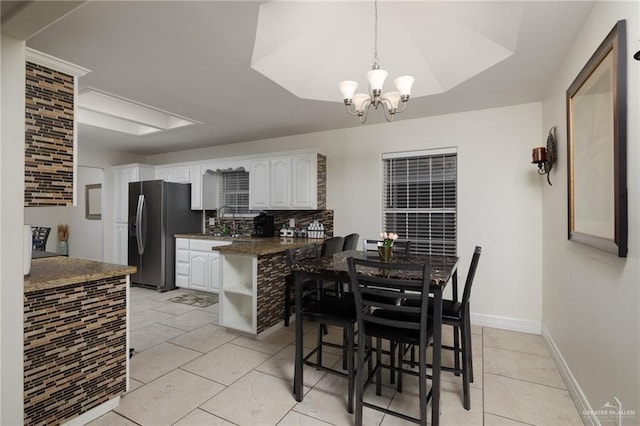 7600 N 23rd Cir, Mcallen, TX 78504 - dining space featuring a chandelier, baseboards, and light tile patterned flooring