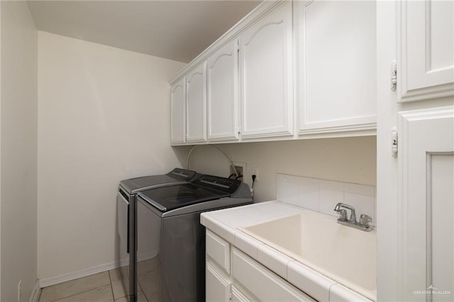 7600 N 23rd Cir, Mcallen, TX 78504 - laundry room with cabinet space, washing machine and clothes dryer, light tile patterned floors, and baseboards