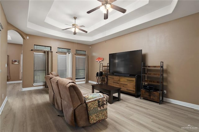 1614 Gabriels Lndg, Harlingen, TX 78550 - living room featuring a raised ceiling, a ceiling fan, arched walkways, and baseboards