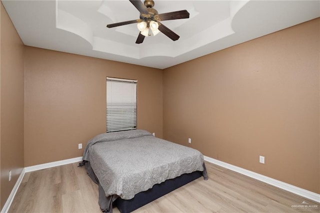 1614 Gabriels Lndg, Harlingen, TX 78550 - bedroom with a raised ceiling, light wood-style flooring, baseboards, and a ceiling fan