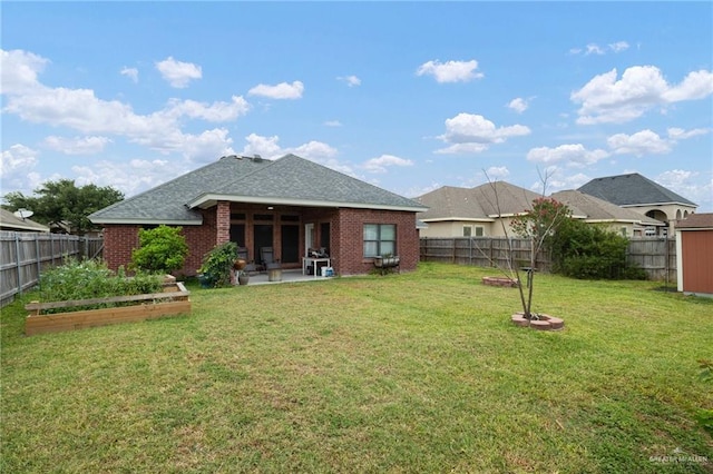 1614 Gabriels Lndg, Harlingen, TX 78550 - rear view of property with a vegetable garden, brick siding, roof with shingles, and a patio area