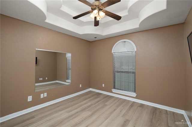 1614 Gabriels Lndg, Harlingen, TX 78550 - empty room with a tray ceiling, wood finished floors, a ceiling fan, and baseboards