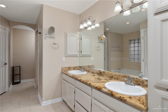 1614 Gabriels Lndg, Harlingen, TX 78550 - full bath featuring double vanity, a bathtub, tile patterned flooring, baseboards, and recessed lighting