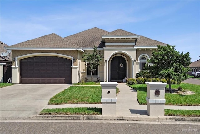 2000 Queens Ave, Mcallen, TX 78504 - mediterranean / spanish-style home with a garage, driveway, stucco siding, a shingled roof, and a front lawn
