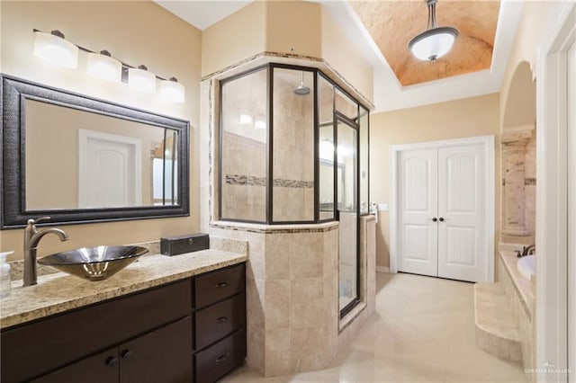 2000 Queens Ave, Mcallen, TX 78504 - bathroom with a stall shower, vanity, a garden tub, tile patterned flooring, and a tray ceiling