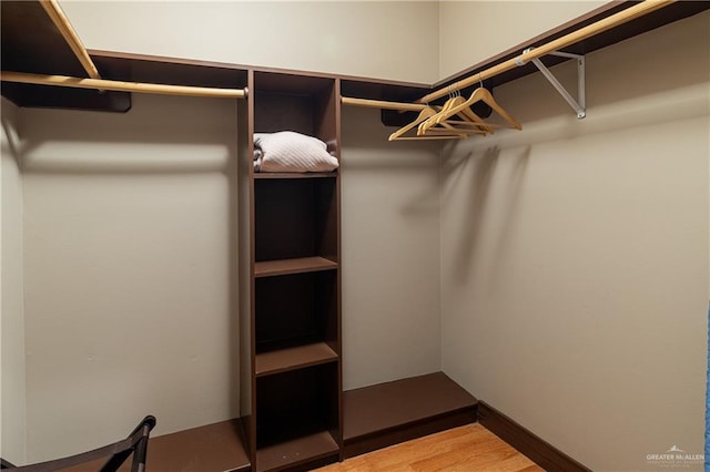 walk in closet featuring wood finished floors