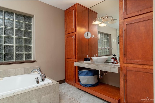 bathroom with tile patterned flooring and a bath