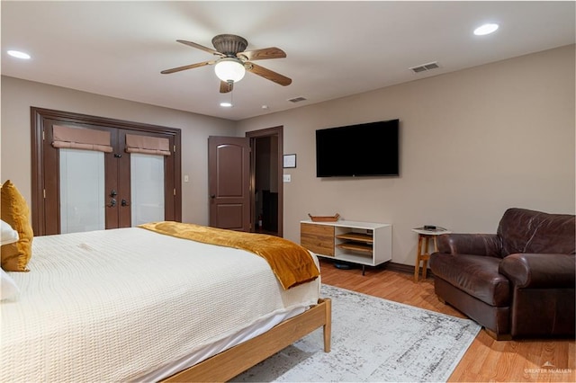 bedroom featuring french doors, recessed lighting, visible vents, and light wood-style floors