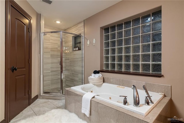 bathroom with a stall shower, tile patterned flooring, visible vents, and a jetted tub