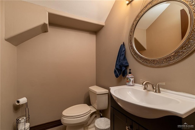 bathroom featuring toilet and vanity