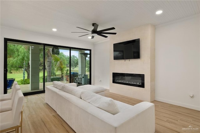 807 Cimarron Dr, Mission, TX 78572 - living area with a glass covered fireplace, a ceiling fan, light wood-style floors, recessed lighting, and baseboards