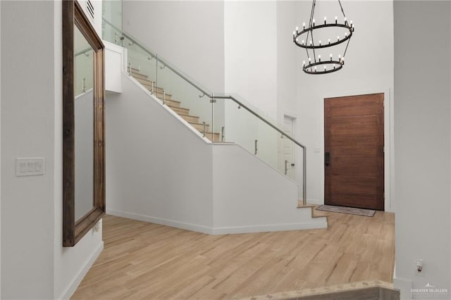 807 Cimarron Dr, Mission, TX 78572 - foyer entrance with wood finished floors, baseboards, stairs, a chandelier, and a high ceiling