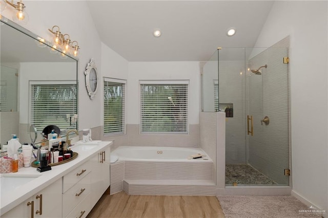 807 Cimarron Dr, Mission, TX 78572 - bathroom featuring a shower stall, a bath, double vanity, lofted ceiling, and recessed lighting