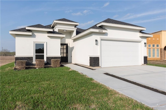 prairie-style home featuring a garage and a front lawn