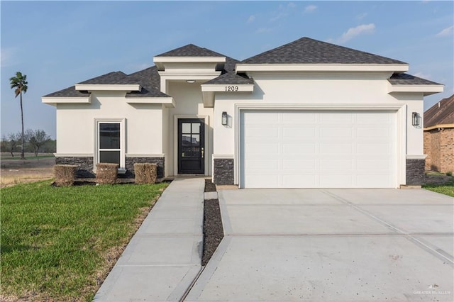 prairie-style home featuring a garage and a front yard