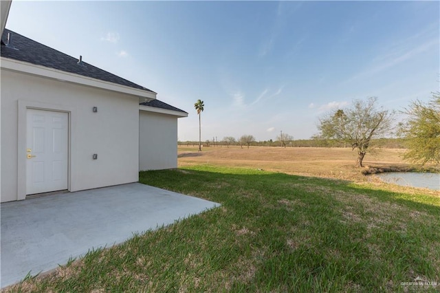 view of yard with a patio and a rural view