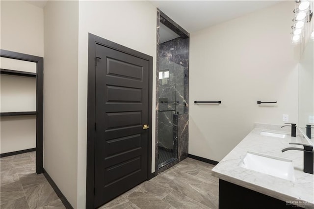 bathroom featuring vanity and a shower with door