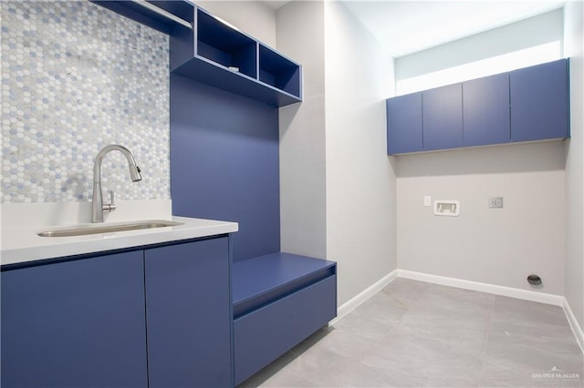 laundry room featuring hookup for a washing machine, sink, and cabinets