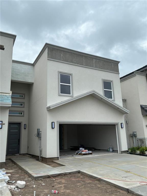 2213 Dorado Dr, Mission, TX 78573 - view of front of home with stucco siding, driveway, and an attached garage