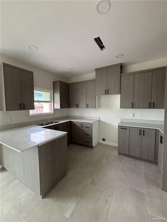 2213 Dorado Dr, Mission, TX 78573 - kitchen with a peninsula, light countertops, light tile patterned floors, and recessed lighting