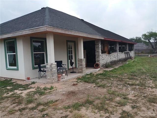1020 S Georgia Ave, Mercedes, TX 78570 - back of property with covered porch, roof with shingles, and stucco siding
