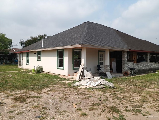 1020 S Georgia Ave, Mercedes, TX 78570 - back of property with stucco siding, a yard, a shingled roof, and a patio area