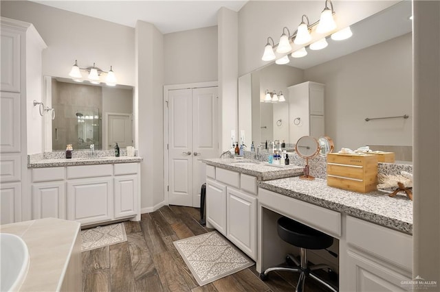 bathroom with vanity, wood-type flooring, and a shower with door