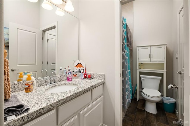 bathroom featuring toilet and vanity