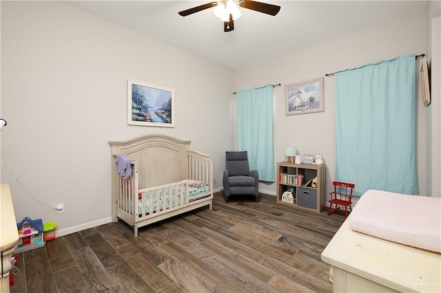 bedroom with ceiling fan and a crib