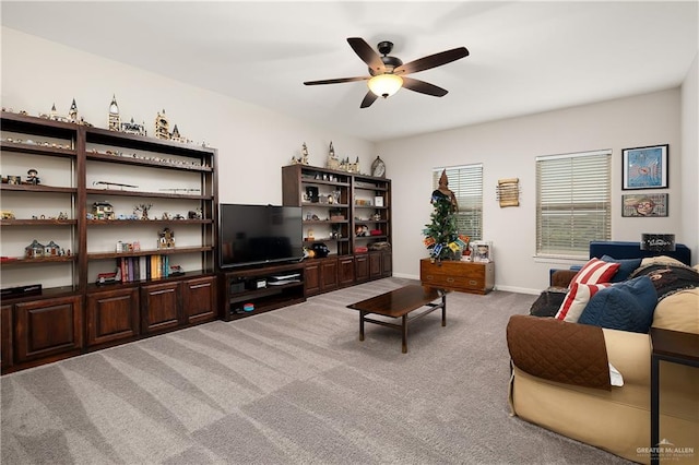 carpeted living room with ceiling fan