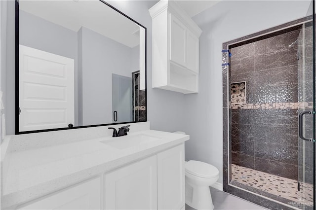 bathroom featuring toilet, walk in shower, and vanity