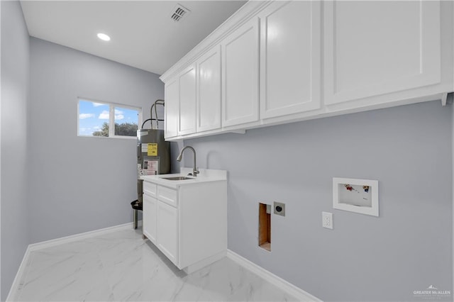 laundry room with sink, hookup for a washing machine, hookup for an electric dryer, cabinets, and electric water heater